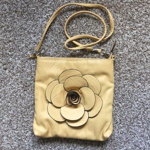Yellow leather purse with detachable strap.